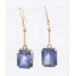 A pair of synthetic sapphire drop earrings, both set with an emerald cut synthetic sapphire,