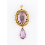 An amethyst pendant / brooch, set with a central oval cut amethyst, measuring approx. 23x17mm,