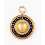 A 9ct yellow gold football medallion, decorated with central football cap and enamelled with '