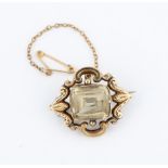 A Victorian citrine brooch, set with a central cushion cut citrine surrounded by open metalwork