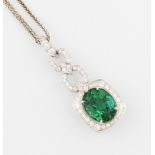 A green tourmaline and diamond pendant, set with an oval cut green tourmaline, measuring approx.