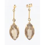 A pair of smoky quartz dropper earrings, each set with a marquise cut smoky quartz, measuring