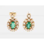 A pair of emerald and diamond cluster stud drop earrings, each set with a central oval mixed cut