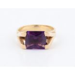 An amethyst dress ring, set with a rectangular cut amethyst, measuring approx. 10x9mm, within raised