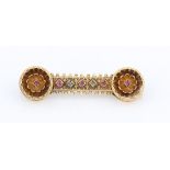 A Victorian Gothic revival ruby and emerald bar brooch, set in unmarked yellow metal, length approx.