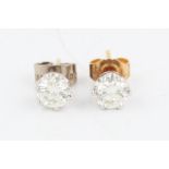 A pair of diamond stud earrings, each set with a round brilliant cut diamond, each diamond approx.