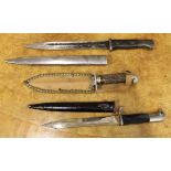 A group of three edged weapons to include German NCO dress bayonet with black handle and scabbard,