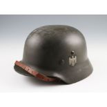 A group of seven reproduction German Nazi M35 and M42 helmets to include examples with camo
