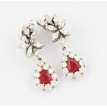 A pair of ruby and diamond stud drop earrings, each featuring graduated round brilliant cut diamonds