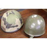 A French paratrooper helmet with camo cover, dated 1987, together with another similar green,