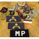 A collection of assorted military cloth insignia, mostly British including air force, naval and army