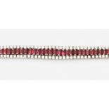 A ruby and diamond line bracelet, featuring a line of approx. 56 graduated rectangular cut rubies,