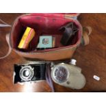 A Bell & Howell camera model 605, an Agfa Speedex O camera, an exposure meter and range finder.