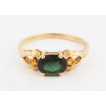 A 9ct yellow gold green sapphire ring, set with a central oval cut green sapphire, measuring approx.