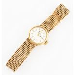 A 9ct yellow gold Omega ladies wrist watch, the silver tone dial having hourly baton markers,