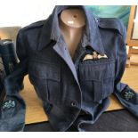 A 1945 dated RAF tunic with wing cloth badges together with torso mannequin.