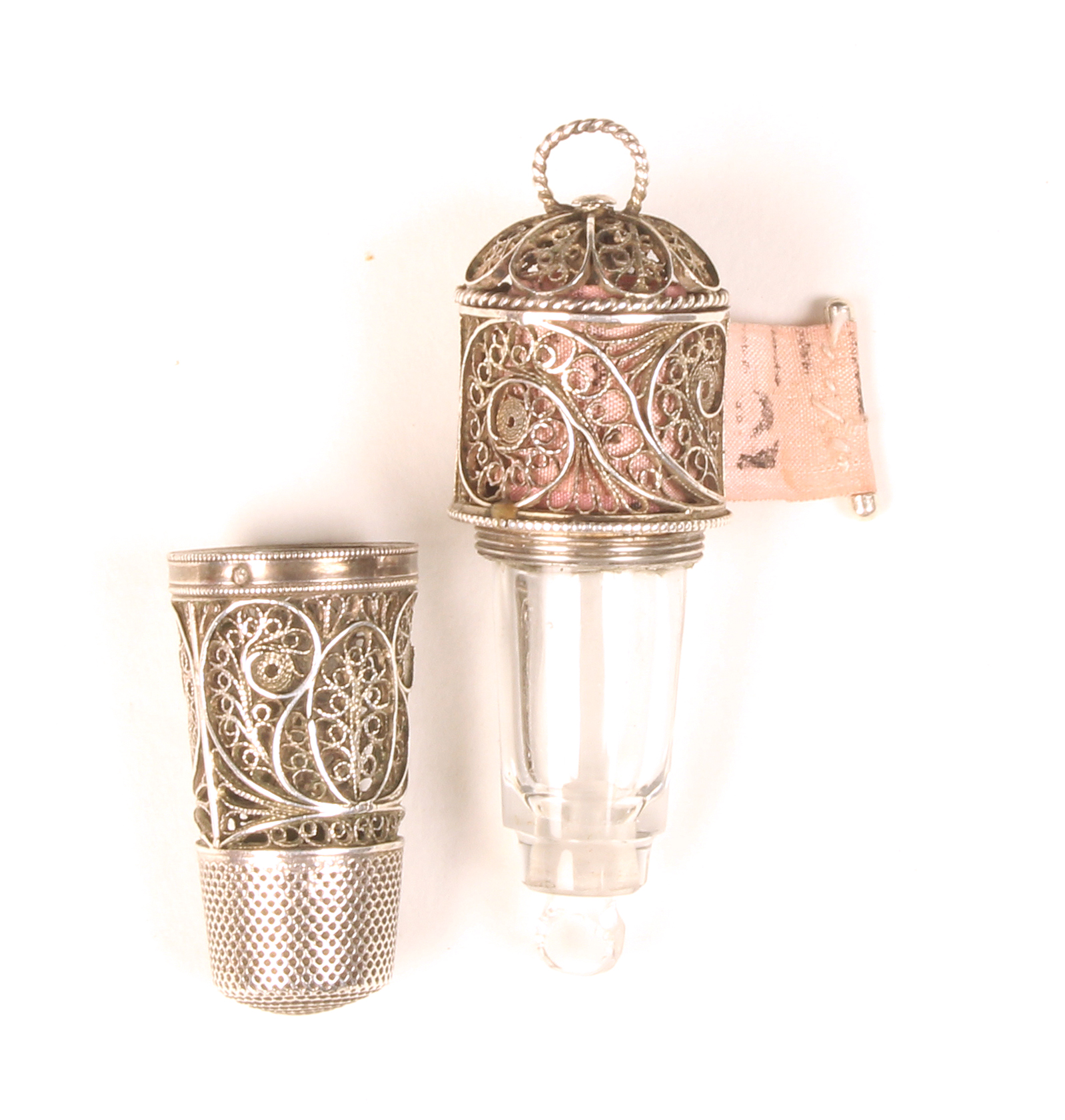 A good early 19th Century silver filigree combination thimble/scent bottle/tape measure, the thimble