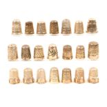 Twenty one English hall marked silver thimbles, including a set of four emblamatic of the assay