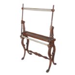 An attractive carved oak floor standing embroidery frame, the screw frame on fluted pillar