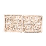 A lady’s silver buckle, each half pierced and cast with four panels of leaves within a rectangular