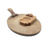 A ‘Mouseman’ Thompson oval oak bread board and an ash tray of rectangular form canted to one end and