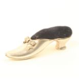 A large silver pin cushion in the form of a lady’s elegant shoe, engraved tied ribbon bow, Chester