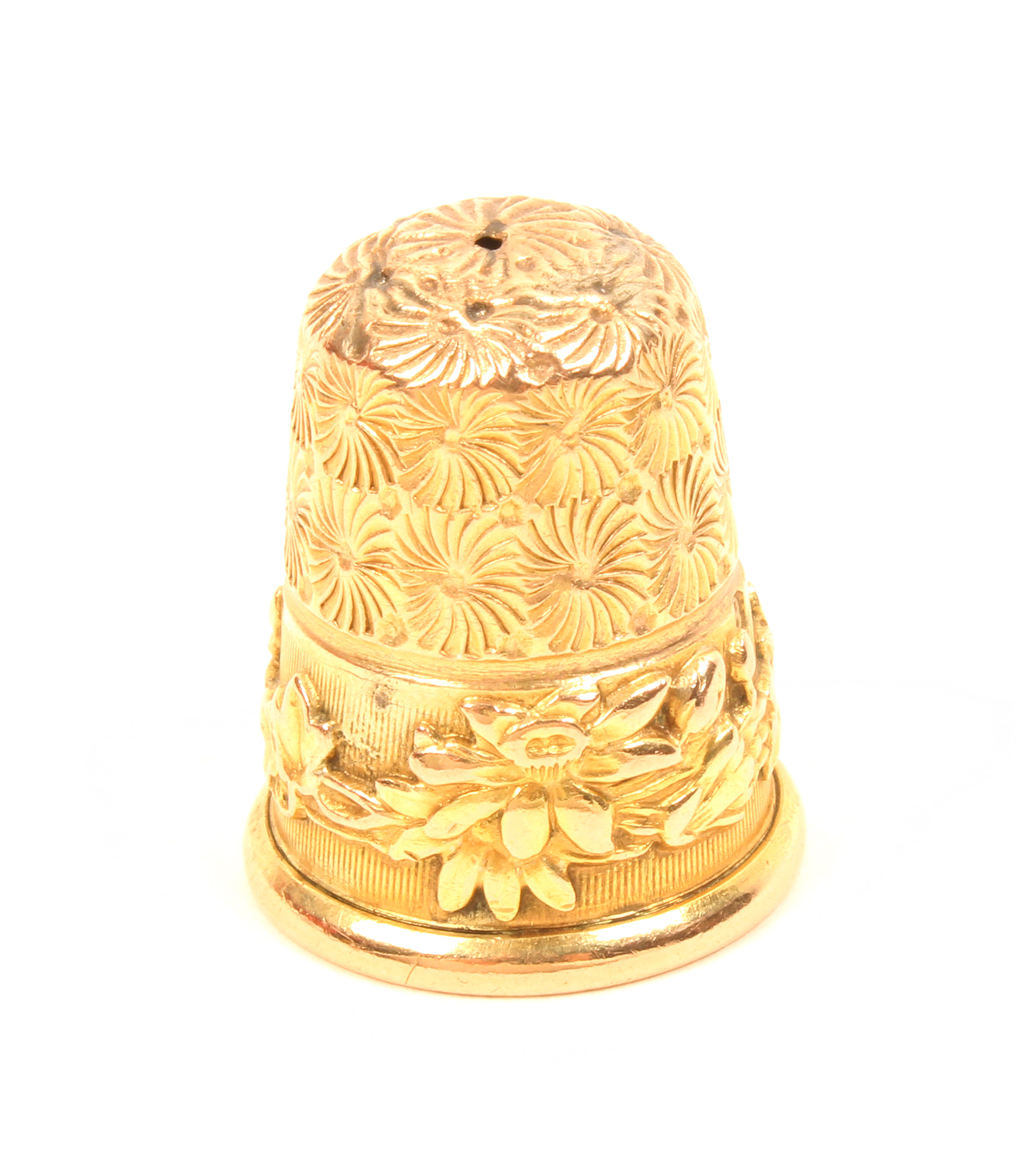 A 9ct. gold thimble by Charles Horner, the ribbed frieze with overlaid floral band.