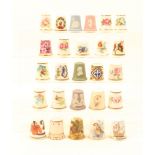 A collection of ceramic thimbles comprising a modern Meissen example, four Wedgwood jasper ware