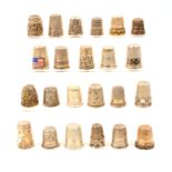 Twenty three continental and other white metal and silver thimbles most with decoration. (23)