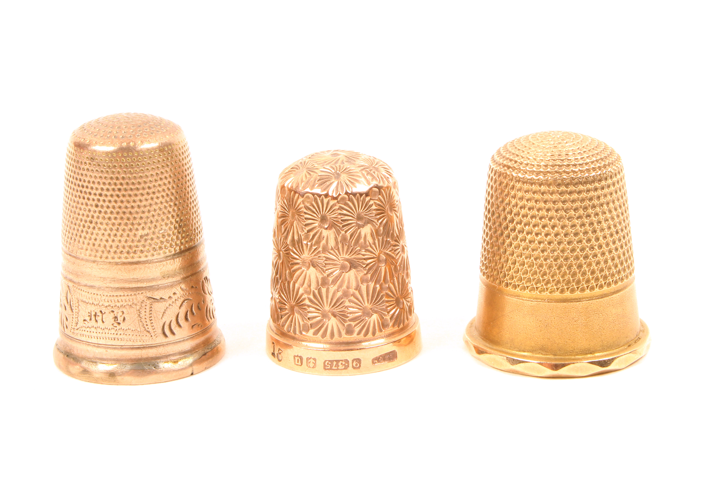 A 9ct. gold thimble and two others, the gold example by Henry Griffiths and Sons. (3)