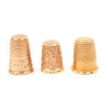 A 9ct. gold thimble and two others, the gold example by Henry Griffiths and Sons. (3)