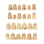 Twenty four English hall marked silver thimbles including three with stone tops. (24)