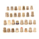 Thirty continental and white metal thimbles including four with enamel decoration, three with