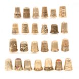 Twenty five continental and other white metal and silver thimbles most with decoration. (25)