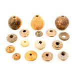 A collection of seventeen loom weights and spindle whorls of variant forms in pottery, stone, lead