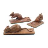 Three carved figures of mice in various poses, two in mahogany and one in oak, each signed with