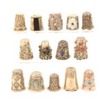Fourteen thimbles in white metal comprising three leaf scroll decorated examples, probably Indian,