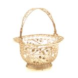 A 19th Century Dutch silver filigree wool basket, swing handle with central vacant cartouche, by