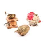 Three novelty tape measures comprising a copper and brass example in the form of a coffee grinder, a