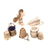 Five silver and white metal thimble cases and stands comprising a double thimble stand in the form