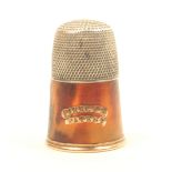 An early 19th Century Piercy’s Patent thimble in silver, tortoiseshell and gold, the frieze