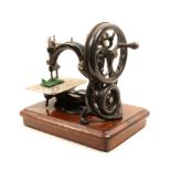 A Victorian Willcox And Gibbs sewing machine, the stitch plate with stitches to an inch adjustment