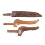 Three 19th Century goose wing form knitting sheaths, one in laburnum 29.5cm, and two in fruitwood