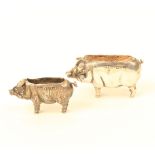 Two silver pin cushions each as a standing pig, the larger Chester, 1909, 4.5cm, the smaller with