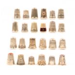 Twenty four continental and American white metal and silver thimbles including four with stone tops.