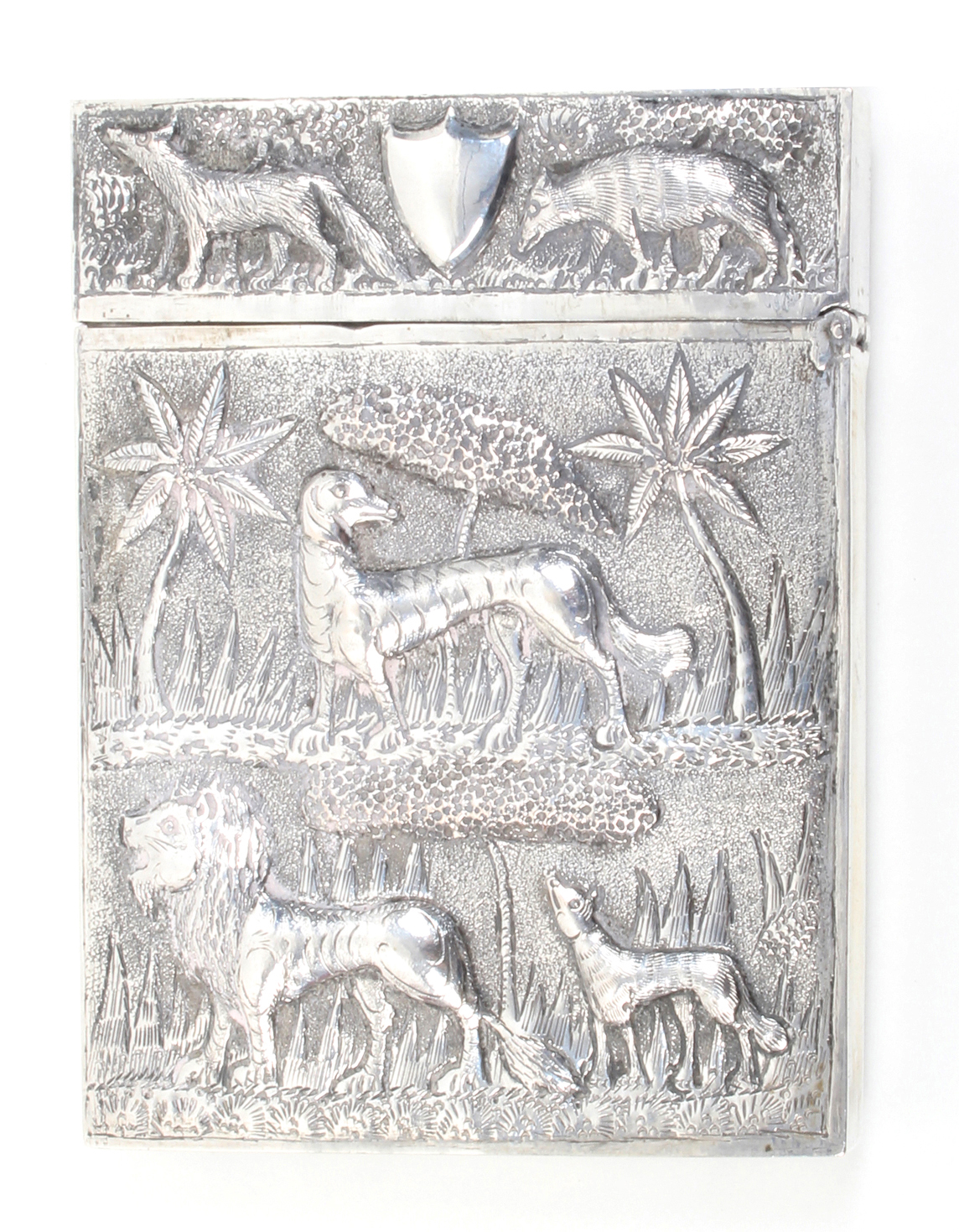 An Anglo-Indian silver visiting card case each side decorated with animals and vegetation in relief,