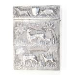 An Anglo-Indian silver visiting card case each side decorated with animals and vegetation in relief,