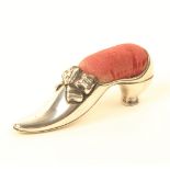 A silver pin cushion in the form of an elegant lady’s shoe with tied ribbon bow, Birmingham 1901, by