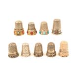 Nine decorative silver thimbles, three English, one with pierced frieze, a cable style, another