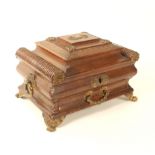 A fine Regency brown leather covered sewing box of elaborate sarcophagus form, with tooled and other